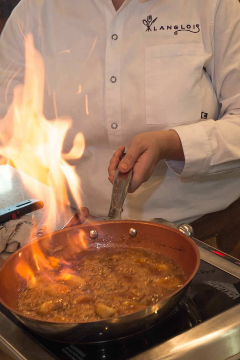 Chef flambes traditional New Orleans Bananas Foster for private event