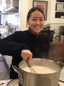 a langlois guest stirring the pot in the kitchen during a cooking class