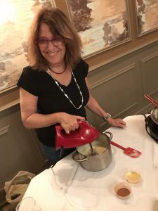 A lady cooking in Creole Brunch Cooking class